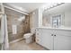 Bathroom featuring a glass shower with a seat and a vanity with double sinks and white cabinets at 5855 Midnight Pass Rd # 319, Sarasota, FL 34242