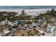 The aerial view showcases a beachside park, playground and recreational area with lush landscaping and a beach nearby at 5855 Midnight Pass Rd # 319, Sarasota, FL 34242