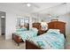 Bright bedroom with twin beds, a ceiling fan, tiled floors, and a mirrored closet at 5855 Midnight Pass Rd # 319, Sarasota, FL 34242