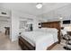 Bedroom with a king bed, mirrored wall, and views to the dining and kitchen area at 5855 Midnight Pass Rd # 319, Sarasota, FL 34242