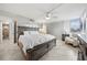 Bedroom with tile flooring, large windows, ceiling fan, and a king bed with mirrored wall at 5855 Midnight Pass Rd # 319, Sarasota, FL 34242