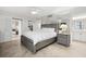 Bedroom featuring a king bed, mirrored wall, ceiling fan, and a doorway to the ensuite bathroom at 5855 Midnight Pass Rd # 319, Sarasota, FL 34242