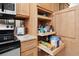The kitchen features stainless appliances, granite countertops, and convenient pull-out cabinet shelving at 5855 Midnight Pass Rd # 319, Sarasota, FL 34242