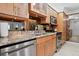 Modern kitchen features stainless steel appliances, light wood cabinetry, and granite countertops at 5855 Midnight Pass Rd # 319, Sarasota, FL 34242