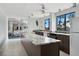 Well-lit kitchenette includes stone counters, dark cabinets, stainless appliances and a servery pass through at 5855 Midnight Pass Rd # 319, Sarasota, FL 34242