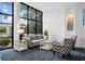 Bright living room featuring large windows, a comfortable sofa, and tasteful decor at 5855 Midnight Pass Rd # 319, Sarasota, FL 34242