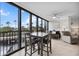 Living room with floor to ceiling windows with views of palm trees, comfortable furniture and neutral decor at 5855 Midnight Pass Rd # 319, Sarasota, FL 34242