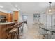 Open-concept living area with bar seating adjacent to a modern dining area at 5855 Midnight Pass Rd # 319, Sarasota, FL 34242
