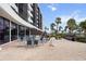 Inviting outdoor area with tables, chairs, and BBQ grills, perfect for social gatherings at 5855 Midnight Pass Rd # 319, Sarasota, FL 34242