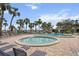 Relaxing community pool and hot tub surrounded by palm trees and lounge chairs, perfect for leisure at 5855 Midnight Pass Rd # 319, Sarasota, FL 34242