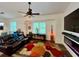 Relaxing living room with fireplace, large TV and comfy leather furniture at 1362 Hedgewood Cir, North Port, FL 34288