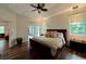 Spacious main bedroom with a king-size bed and dark wood furniture at 1362 Hedgewood Cir, North Port, FL 34288