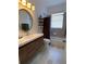 Bathroom with bathtub, modern vanity, and wood-look tile at 1362 Hedgewood Cir, North Port, FL 34288