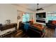 Comfortable living room with a fireplace, large TV, and leather furniture at 1362 Hedgewood Cir, North Port, FL 34288