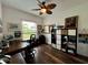 Home office with hardwood floors, desk and ceiling fan at 1362 Hedgewood Cir, North Port, FL 34288