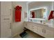 Modern bathroom with white cabinets, a large mirror, and a walk-in shower at 1362 Hedgewood Cir, North Port, FL 34288