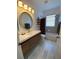 Bathroom with bathtub, modern vanity, and wood-look tile at 1362 Hedgewood Cir, North Port, FL 34288