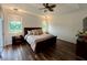 Large bedroom with king-size bed, wood flooring and plenty of natural light at 1362 Hedgewood Cir, North Port, FL 34288