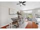 Bright dining area with wooden table, white chairs, and access to a sunroom at 4691 Grobe St, North Port, FL 34287