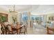 Formal dining room with wooden table and chairs, access to balcony at 990 Blvd Of The Arts # 404, Sarasota, FL 34236