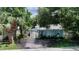 Light blue single-story house with a covered patio and landscaping at 1569 7Th St, Sarasota, FL 34236