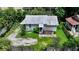 Single-story house with a metal roof, surrounded by trees and a small yard at 1569 7Th St, Sarasota, FL 34236