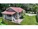 Single-story house with a red roof, front porch, and a small fenced yard at 1569 7Th St, Sarasota, FL 34236