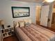 Cozy bedroom with a double bed and a calming coastal painting at 5530 Denmark Dr, Bradenton, FL 34207