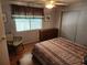 Cozy bedroom with wood floors, dresser, and a comfortable bed at 5530 Denmark Dr, Bradenton, FL 34207