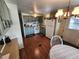 Eat-in kitchen, featuring white appliances and light green cabinetry at 5530 Denmark Dr, Bradenton, FL 34207