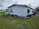 View of home's exterior, showing white siding and landscaping at 5530 Denmark Dr, Bradenton, FL 34207