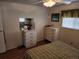 Bedroom with wood floors, double bed, and dresser at 5530 Denmark Dr, Bradenton, FL 34207