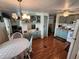 Kitchen with a dining area, light green cabinets, and wood floors at 5530 Denmark Dr, Bradenton, FL 34207