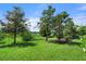 Landscaped backyard with lush greenery and trees at 729 Tailwind Pl, Sarasota, FL 34240