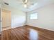 Bright bedroom with wood-look floors, ceiling fan, and ample closet space at 3276 Westford Ln, #117,, Sarasota, FL 34231