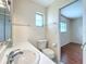 Simple bathroom with toilet, sink, and access to bedroom at 3276 Westford Ln, #117,, Sarasota, FL 34231