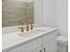 Modern bathroom with copper-colored fixtures and a white vanity at 1625 Compass Pointe Ct # 105, Punta Gorda, FL 33950