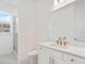 Bright bathroom featuring white vanity, quartz countertop and a glass enclosed shower at 1625 Compass Pointe Ct # 105, Punta Gorda, FL 33950