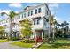 Charming three-story townhouse with modern architectural details, lush landscaping, and a welcoming curb appeal at 1625 Compass Pointe Ct # 105, Punta Gorda, FL 33950