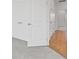 Hallway featuring wood flooring, a walk-in closet, and white painted walls and trim at 1625 Compass Pointe Ct # 105, Punta Gorda, FL 33950