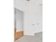 Hallway showcasing hardwood floors and white doors with closets at 1625 Compass Pointe Ct # 105, Punta Gorda, FL 33950