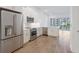 Bright kitchen with stainless steel appliances, white cabinetry, and a view to the outdoor balcony through sliding glass doors at 1625 Compass Pointe Ct # 105, Punta Gorda, FL 33950