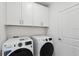 Bright laundry room with modern washer and dryer, plus ample storage at 1625 Compass Pointe Ct # 105, Punta Gorda, FL 33950