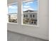 Bright window view with a glimpse of blue sky, the neighborhood, and charming neighboring architecture at 1625 Compass Pointe Ct # 105, Punta Gorda, FL 33950