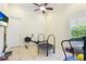 Exercise room with tile floor, exercise equipment, and a ceiling fan at 3342 Founders Club Dr, Sarasota, FL 34240