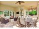 Covered patio features ample seating and an outdoor kitchen with views of the backyard at 3342 Founders Club Dr, Sarasota, FL 34240