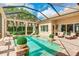 Inviting screened pool area with lush landscaping and clear turquoise water at 3342 Founders Club Dr, Sarasota, FL 34240