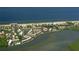 Aerial view of waterfront condo community surrounded by water with beach in distance at 4380 Exeter Dr # 303, Longboat Key, FL 34228