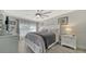 Spacious bedroom with ceiling fan, gray bedding, and white dresser at 4380 Exeter Dr # 303, Longboat Key, FL 34228