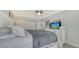Comfortable bedroom with a ceiling fan and a dresser at 4380 Exeter Dr # 303, Longboat Key, FL 34228